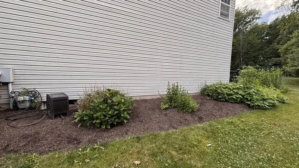 A garden bed refreshed with mulch by A&V